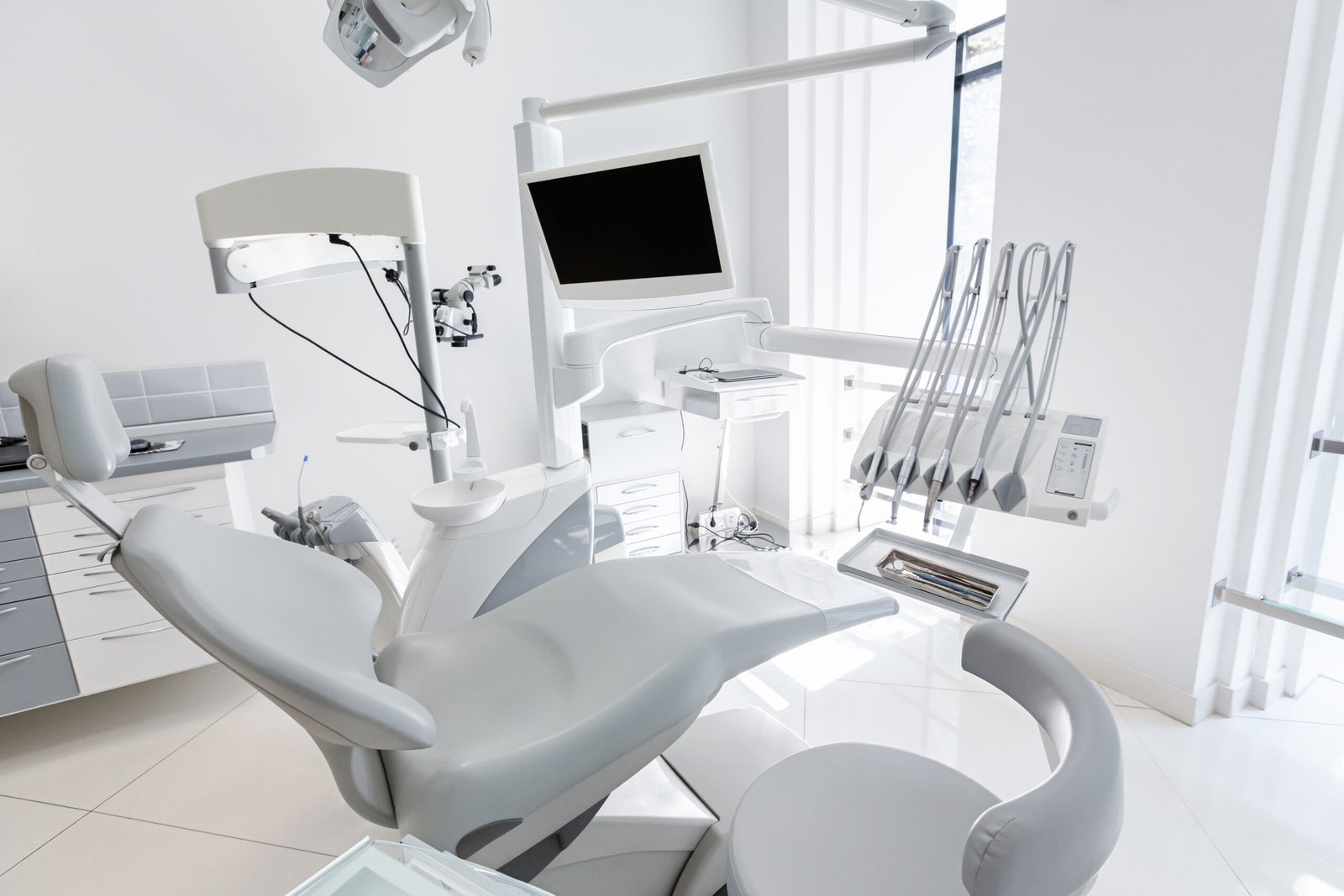 Modern dental clinic renovation in Dubai featuring an ergonomic patient chair and medical equipment.